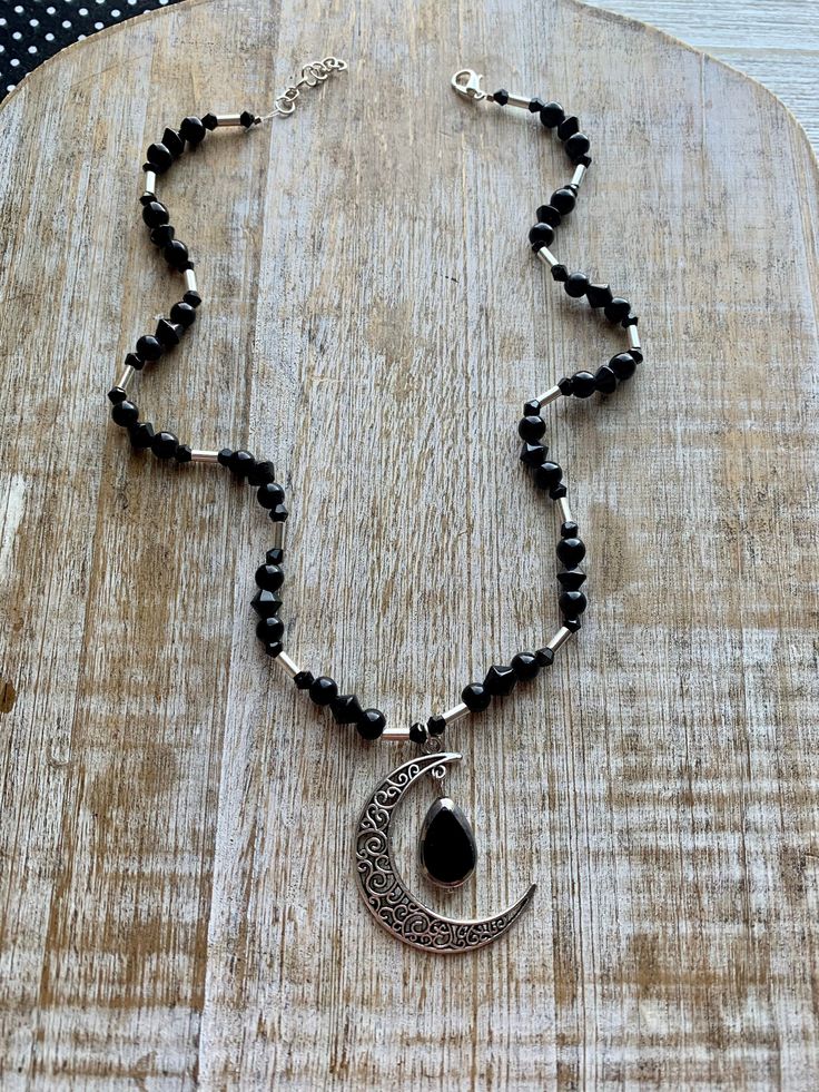 🌙 Crescent Moon Necklace Handmade with glass beads. Necklace measures 18-19 inches long. This necklace will be restrung onto heavier duty bead wire to ensure it lasts for a longer time. This will not change the overall look of the necklace. Adjustable Black Wire Wrapped Beaded Necklaces, Adjustable Black Wire Wrapped Beaded Necklace, Adjustable Black Moon Charm Necklace, Handmade Black Moon Necklace, Spiritual Black Necklace With Moon Charm, Halloween Heels, Wicca Necklace, Dark Fae, Wiccan Necklace