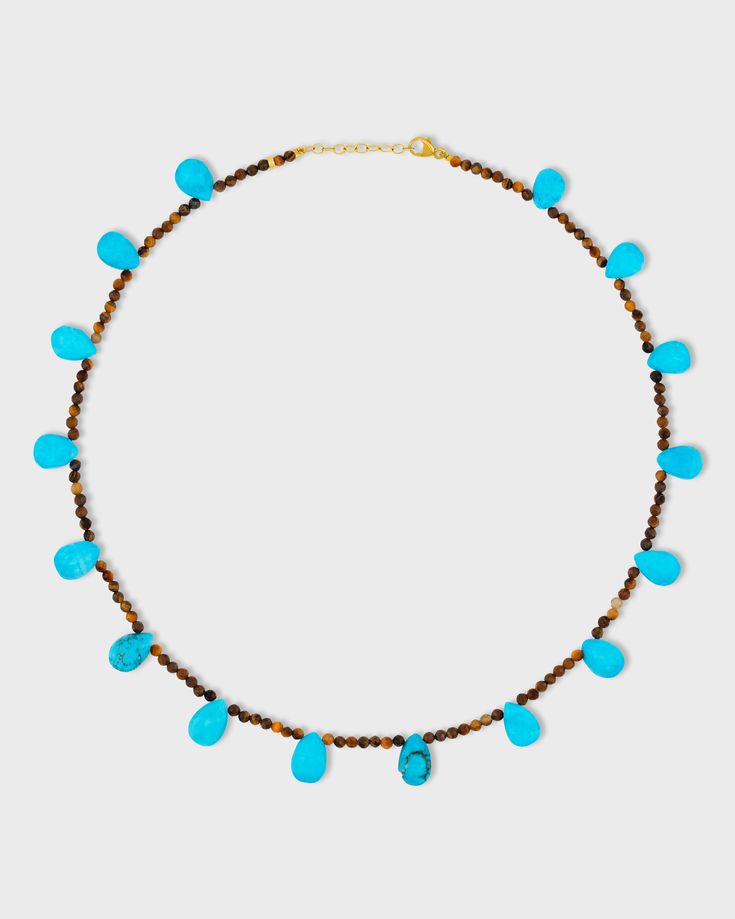 This captivating necklace showcases the rich warmth of Tiger’s Eye paired with the bold blue of Turquoise drops. It combines earthy tones with vibrant pops of color, creating a balanced and eye-catching accessory. 14 karat yellow gold Tigers Eye 16 to 17 inches length 3mm bead size Style # JJ-NAZ-405 UPC 810109745944 Turquoise Briolette Gemstone Bead Necklaces, Turquoise Teardrop Faceted Beads Jewelry, Turquoise Briolette Gemstone Necklace, Turquoise Teardrop Faceted Jewelry, Turquoise Teardrop Necklace With Faceted Beads, Turquoise Faceted Briolette Necklaces, Turquoise Faceted Briolette Necklace, Primal Instincts, Playful Pose