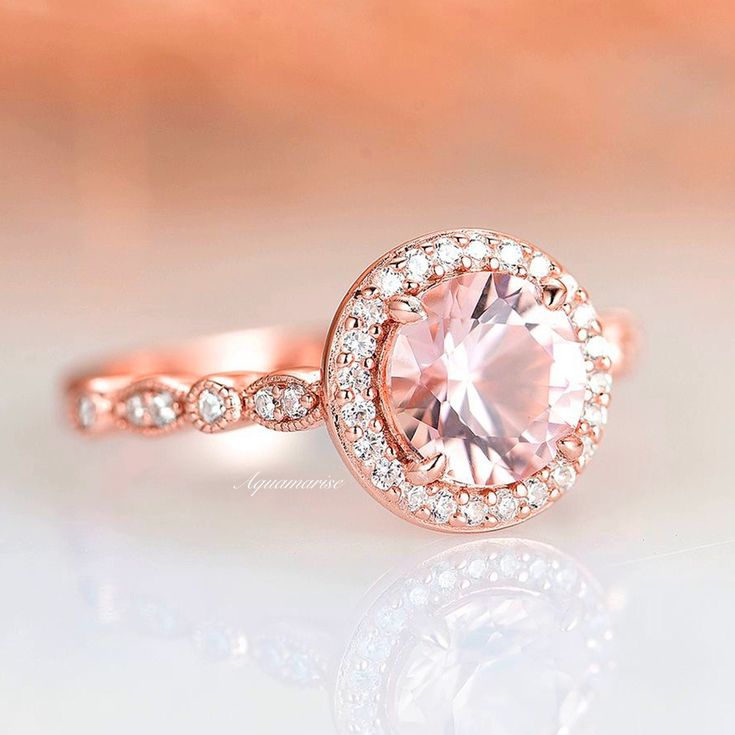 Elegant Pink Diamond Anniversary Ring, Elegant Pink Diamond Ring For Anniversary, Formal Pink Round Cut Halo Ring, Pink Round Cut Halo Ring For Formal Occasions, Formal Pink Halo Ring With Round Cut, Classic Pink Halo Ring, Formal Pink Wedding Ring With Halo Setting, Classic Rose Gold Morganite Wedding Ring, Pink Halo Diamond Ring For Anniversary