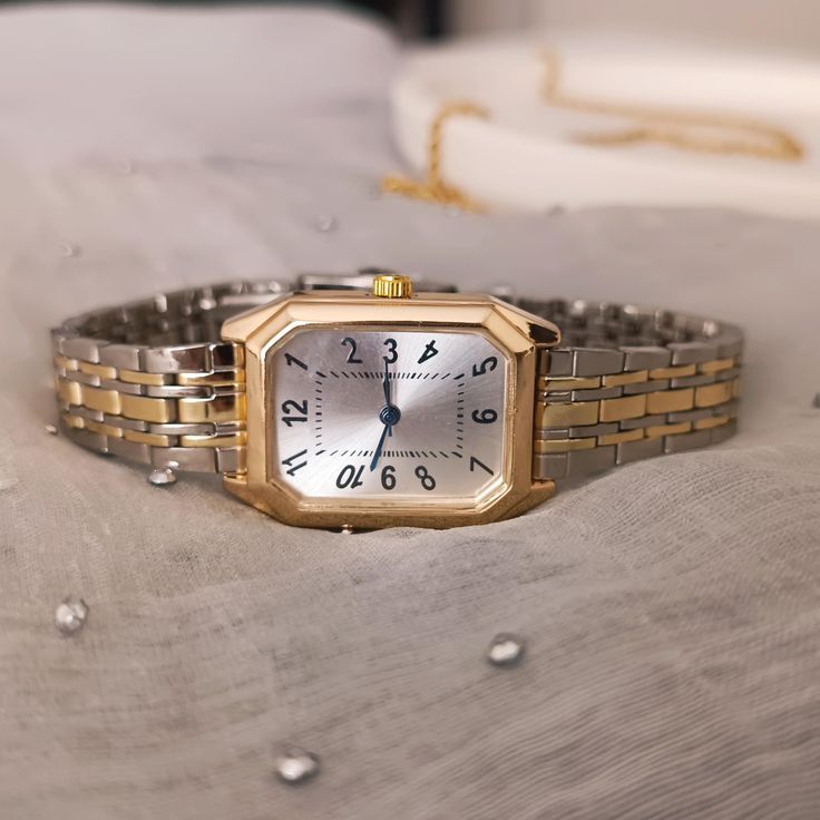 Enhance your style with this elegant women's gold and silver two-tone watch. Designed to offer both sophistication and practicality, this exquisite timepiece is the perfect accessory for any occasion. ✈All Orders Express Shipping Via UPS or FedEx 💎 Product Specifications: ➡ Case Diameter: 20mm x 30mm ➡ Material: Stainless stell ➡ Case Color: Gold ➡ Band Color: Silver and Gold ➡ Dial Shape: Rectangular  ➡ Strap Type: Metal Band ➡ Movement: Quartz ➡  Key Features: 💎 Stylish Two-Tone Design: The Rectangular Quartz Watch For Everyday Use, Classic Square Watch Accessories For Gifts, Watches With Bracelet Strap And Rectangular Dial, Watches With Adjustable Bracelet Strap And Rectangular Dial, Everyday Rectangular Watches With Metal Dial, Adjustable Watches With Bracelet Strap And Rectangular Dial, Timeless Rectangular Watch With Adjustable Fit, Timeless Adjustable Rectangular Watch, Vintage Rectangular Watch For Everyday