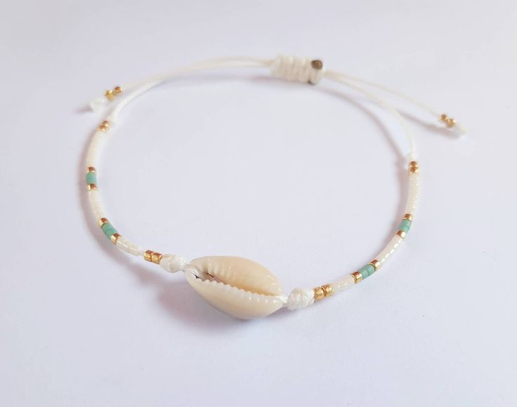 Shell bracelet with string cord and miyuki beads for Friendship gift, beach style  Beautiful adjustable wax cordon bracelet this cute waxed polyester bracelet is  made up of tiny japanese Miyuki 11/0  beads mix and tiny shell. You can choose the color during your shipping.  You have choice between light green  ( vert clair) , orange,  pink ( rose) and Caribbean blue ( bleu caribéen). The wax polyester cord is a high quality cord and waterproof. The bracelet can be adjusted by a knot you can slid Minimalist Waxed Cord Jewelry For Beach, Minimalist Friendship Bracelets For Summer Gift, White Heishi Beads Friendship Bracelets For Vacation, Summer Gift Heishi Beads Friendship Bracelets, Minimalist Braided Bracelets For Beach, Beach Friendship Bracelets With Tiny Beads, Casual Tiny Beads Friendship Bracelets For Beach, White Adjustable Friendship Bracelets For Beach, Minimalist Adjustable Beaded Bracelets For Summer