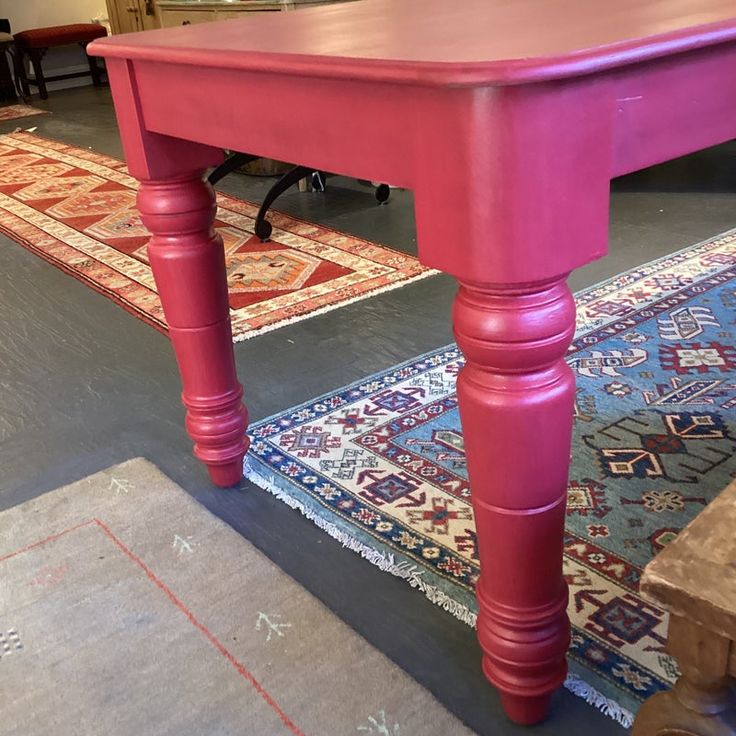 a pink table sitting on top of a rug