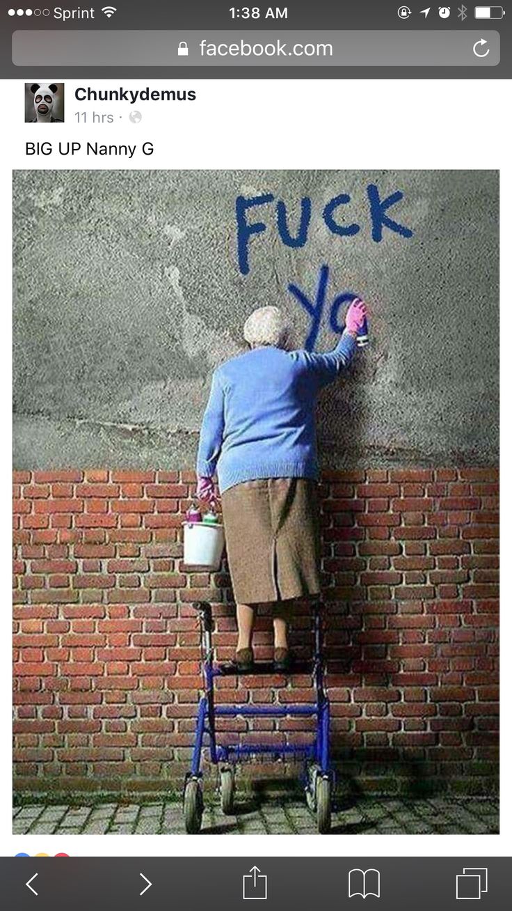 an old woman is leaning on a brick wall with her hand in the air and holding a flower pot