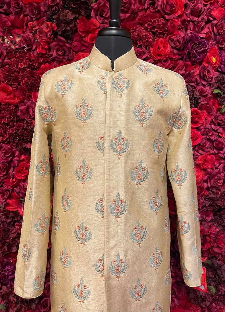 A regal golden sherwani with intricate embroidered details, perfect for grooms seeking a traditional yet majestic look. Key Features: Fabric: Premium brocade with intricate woven patterns Collar: High-neck design with subtle embellishments Buttons: Gold-toned embroidered buttons, adding a sophisticated finish Occasion: Ideal for weddings, receptions, and other grand occasions Color - Linen Off-White Classic Long Sleeve Festive Traditional Wear, Designer Festive Kurta With Stand Collar, Festive Designer Kurta With Stand Collar, Designer Kurta For Reception And Transitional Seasons, Designer Stand Collar Kurta For Festive Occasions, Designer Off-white Bandhgala With Resham Embroidery, Formal Long Sleeve Beige Kurta, Designer Cream Kurta With Naqshi Detailing, Designer Cream Kurta With Naqshi