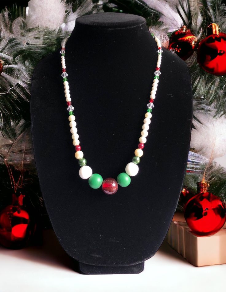 Like to dress formally for the holiday season?  Why not go for this stunning 24-inch-long necklace made with red, green, and white pearl and glass beads for a sophisticated look this Christmas!   The necklace is strung on 18-inch wire, secured with bead crimp beads, bead cover tips and connected to 4-inch linked chain and secured with a lobster claw clasp and 6mm jump ring for easy opening and closing. Caution: avoid banging or dropping necklace on hard surfaces as beads are heavy and will break! Diy Christmas Necklace Ideas, Elegant White Christmas Necklaces, Elegant Holiday Festive Necklaces, Elegant Beaded Necklace For Holiday, Elegant White Necklace For Christmas, Elegant White Holiday Necklaces, Elegant Holiday White Necklaces, Elegant Christmas Holiday Necklaces, Christmas Necklaces With Colorful Beads