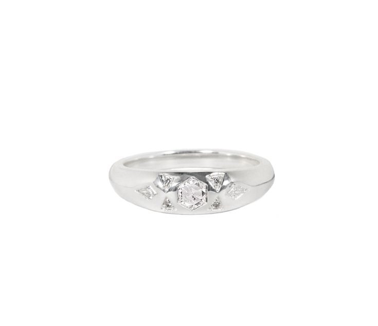 a white gold ring with three diamonds on the top and one diamond in the middle