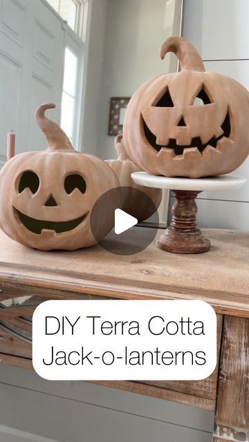 two carved pumpkins sitting on top of a table