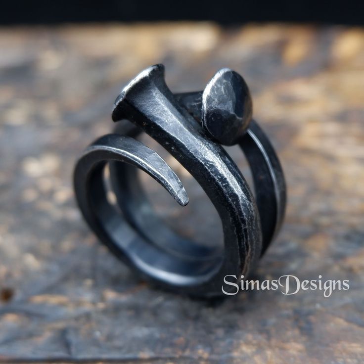 This hand forged, two nails ring is made from iron. Using traditional blacksmithing techniques of fire, hammer and anvil. Surface texture is achieved through different shaped hammers and hand held chisels and profiling tools. The ring has been sealed with Renaissance Wax Polish to protect the metal. Width - up to 20 mm US size - 9 1/4 Presented in a gift bag. European & International orders are sent by Standard post with tracked & signed delivery. 6th Anniversary Gifts, Iron Ring, Viking Ring, Forging Metal, 6th Anniversary, Nail Ring, Wide Ring, Ring Hand, Wide Rings