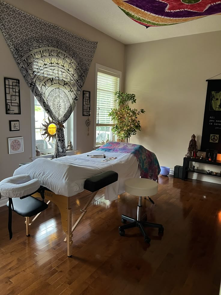 a room with a bed, desk and chair on it in front of a window