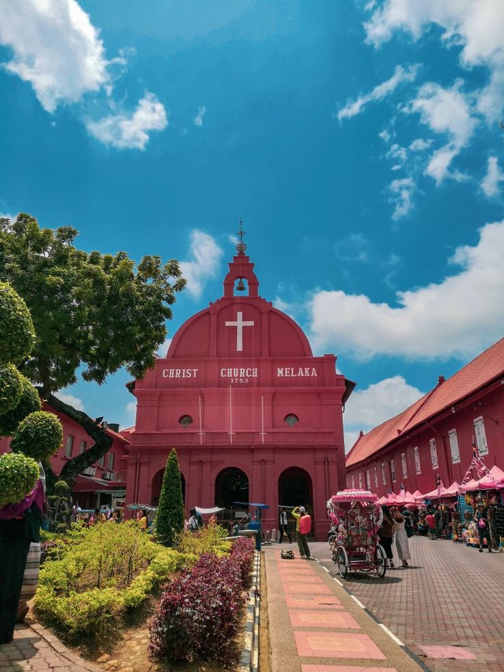 a red building with a cross on it's roof