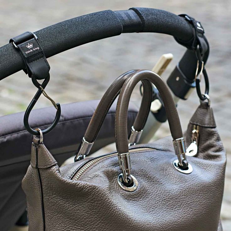 a gray purse sitting on top of a stroller