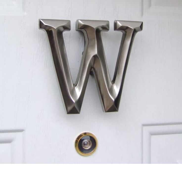 the letter w is attached to a white door