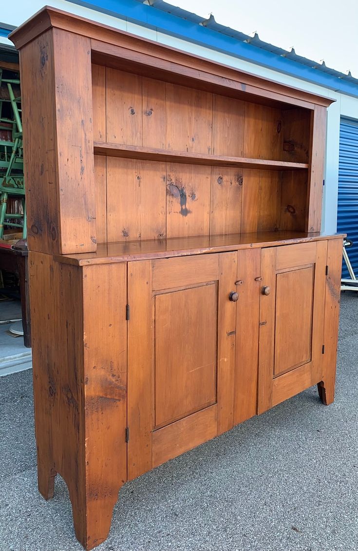 an old wooden cabinet with doors and drawers