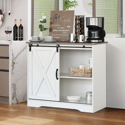 a kitchen with a white cabinet and wooden floors