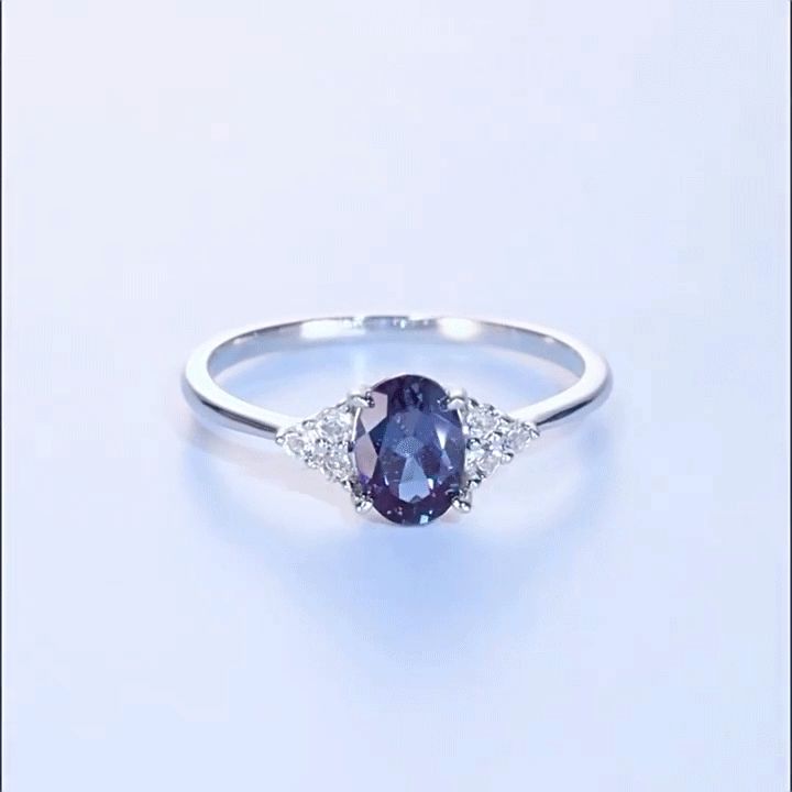 At the center of the ring is a beautiful and mysterious Alexandrite that exudes elegance and charm. Two bright white gemstones adorn the sides, enhancing the charm of the ring and creating a beautiful symphony of harmony. With its timeless design and exquisite craftsmanship, the Alexandrite stone ring is a true reflection of the journey of love. It is a reminder to cherish the past, embrace the present, and embrace the future as the three gemstones come together in harmony to create an everlasting bond.Stone Size: 5*7 mmStone Type: Jeulia® StoneNumber of Stones: 1 Stone Shape: OvalMaterial: 925 SilverPlating Color: Silver Elegant Open Diamond Ring With Gemstone Accents, Elegant Oval Jewelry For Promise, White Gold Sapphire Ring With Diamond Gemstone Accents, Diamond White Oval Crystal Ring With Accent Stones, Elegant Sapphire Diamond Ring With Gemstone Accents, Elegant Oval Sapphire Birthstone Ring, Oval Diamond White Crystal Ring With Accent Stones, Oval Diamond Ring In White Gold With Gemstone Accents, Oval White Gold Birthstone Ring With Diamond Accents