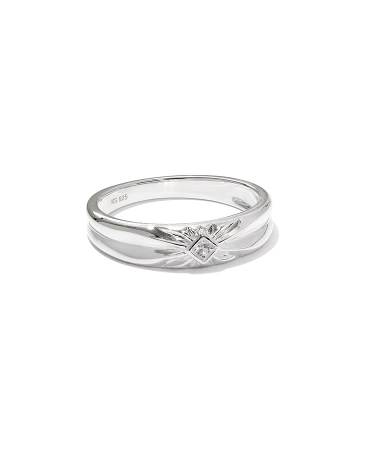 a white gold ring with an arrow on the side and two diamonds in the middle