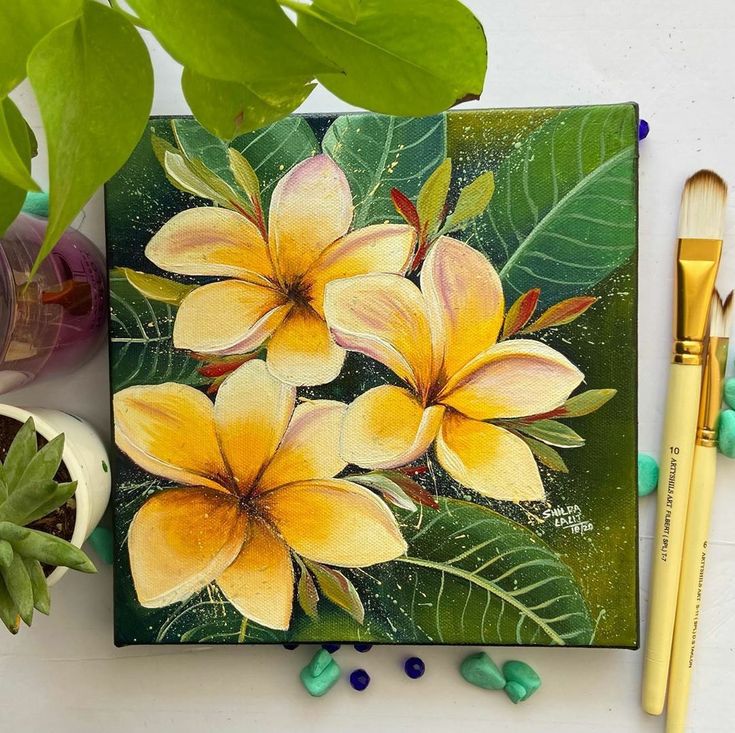 a painting of yellow flowers on a green background next to paintbrushes and paints