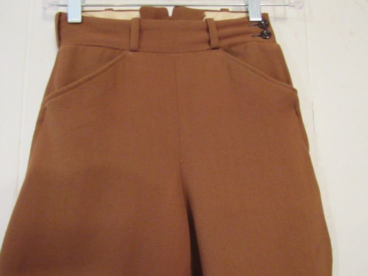 "Vintage 1950s jodhpurs, horse riding pants or motorcycle pants. Made of rust brown wool twill. Has a zip side, two waist pockets and button cuffs. Made by Brittany Riding Apparel. Size small or extra small. Actual measurements are: 21.75\" at the waist 37\" hips 18.5\" inseam 29.5\" overall length In good condition with some spots." Vintage Brown Winter Pants, Brown Vintage Pants For Winter, Classic High Waist Brown Pants, Vintage Fitted Winter Bottoms, Vintage Fitted Bottoms For Winter, Fitted Vintage Bottoms For Winter, Vintage Winter Workwear Bottoms, Vintage Trousers For Winter, Fitted Vintage Brown Bottoms