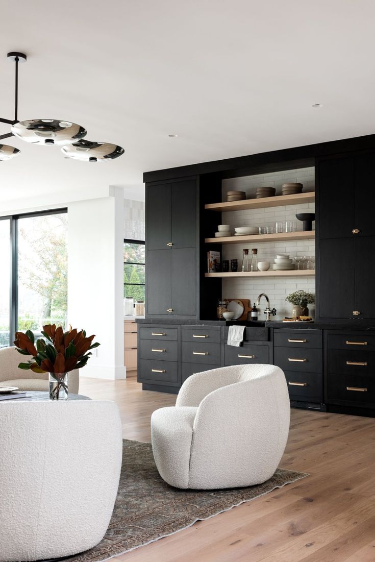 a living room filled with furniture and lots of windows