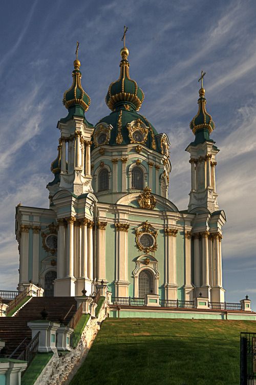 an ornate building with gold and green domes