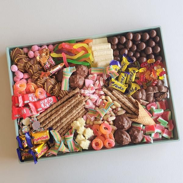 a box filled with lots of different types of candies and chocolates on top of it