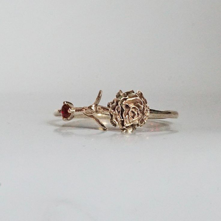 Our special collection of birth flower rings are inspired by the love of wearing something meaningful. Each birth flower is adorned with that month's birthstone. January's birth flower is Carnation and the birth stone is garnet. Materials: 14K solid gold 2mm natural garnet 1.1mm band thickness ** This item is specially made for you. Please allow 1-2 week lead time. Shipping:Domestic: Free standard shipping within the U.S.International: Free standard shipping for orders over $200 Customization:- Nature-inspired Rose Gold Flower Ring As Gift, Heirloom Birth Flower Jewelry For Anniversary, 14k Rose Gold Flower Ring With Birth Flower, 14k Gold Birth Flower Promise Ring, Fine Jewelry Birthstone Flower Promise Ring, Rose Gold Birth Flower Ring, 14k Yellow Gold Flower Ring With Birthstone, Yellow Gold Flower Ring With Birthstone For Gift, 14k Gold Flower Ring With Birthstone For Anniversary