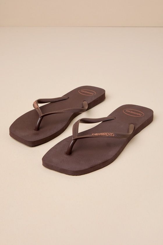 No closet is complete without an iconic go-to look like the Havaianas Slim Square Brown Flip Flops! Two rubber straps (with an embossed logo) shape a classic thong upper atop a comfortable textured foam sole with a trendy square toe bed. Pair these essential cuties with all your sunny days and getaways! Available in Euro sizes only. 0. 5" rubber heel. Cushioned foam insole. Rubber sole has nonskid markings. Man made materials. Imported. Lulus | Slim Square Brown Flip Flops | Size 35/36. Brown Leather Flip Flops, Brown Flip Flops, Logo Shapes, Leather Flip Flops, Shoe Inspo, Rubber Heels, Embossed Logo, Sunny Days, Cute Clothes