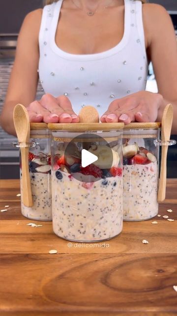 a woman is making some food in two jars