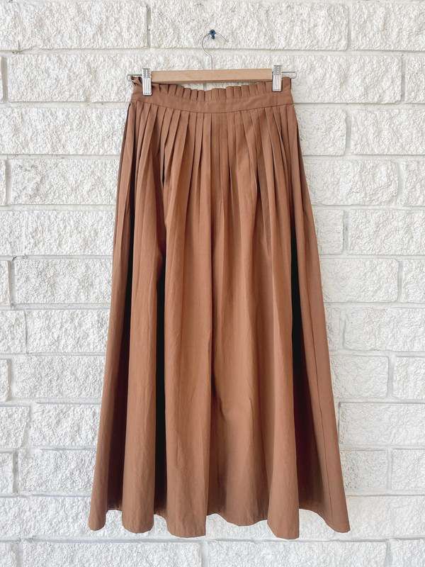 - the treeline skirt by the great in the color suntan  - pleated waistband  - a-line midi skirt  - tie waist  - button front  - pairs back to the hills top Brown Flowy Pleated Skirt For Spring, Brown Full Maxi Skirt For Spring, Brown Lined Maxi Skirt For Work, Brown Flared Maxi Skirt For Work, Brown Relaxed Maxi Skirt For Work, Chic Brown Full Skirt Bottoms, Brown Full Maxi Skirt For Work, Brown Pleated Maxi Skirt For Summer, Pleated Midi Maxi Skirt For Day Out