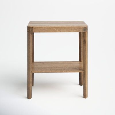 a small wooden table sitting on top of a white floor