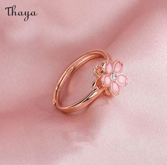 Capture the essence of cherry blossom season with our Silver Sakura Spinner Ring. This elegant piece tells a story of beauty and renewal, as delicate petals bloom and dance in the breeze. The spinner design allows for a soothing sensation, perfect for those seeking balance and serenity in their daily lives. Elevate your style with this stunning symbol of hope and new beginnings.   - Brand: Thaya  - Material: S925 Silver  - Weight : About 2.34g  - Size: Stack Mouth 14th  - Style: Flower  - Gender: Women Delicate Flower Ring For Spring Gift, Delicate Spring Flower Ring Gift, Feminine Blossom Jewelry For Spring, Rose Gold Jewelry For Anniversary In Spring, Rose Gold Jewelry For Spring Anniversary, Flower Shaped Wedding Rings For Spring, Spring Rose Gold Flower Jewelry, Spring Rose Gold Flower Ring, Spring Wedding Jewelry With Petal Design