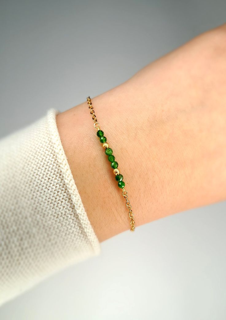 This bracelet is handmade with natural high quality gemstones. The materials used are nickel-free and are also suitable for sensitive skin. Information about the product: Length: approx. 17 cm (+ 3 cm extension chain) Weight: approx. 3g Gemstones: - Diopside Material: - 18k gold-plated elements (including clasp) The right care: The product was made with delicate materials. The color may change in contact with sweat, deodorant, perfume, water or other liquids. Store the product in a dry place and remove it before showering or bathing. Please also follow my Instagram account: @gems_jewels_byanni Thank you for your visit! Gold Plated Beaded Bracelets With Adjustable Chain For Gift, Green Gold Plated Bracelet As A Gift, Gold Plated Bracelets With Natural Stones For Gift, Handmade Gold Bracelets With May Birthstone, Gold Bracelets With Natural Stones For May Birthstone, Handmade Gold Bracelets For May Birthstone, Minimalist Gold Bracelets With May Birthstone, Green Jewelry With Extender As Gift, Gold Crystal Bracelet For May Birthstone Gift