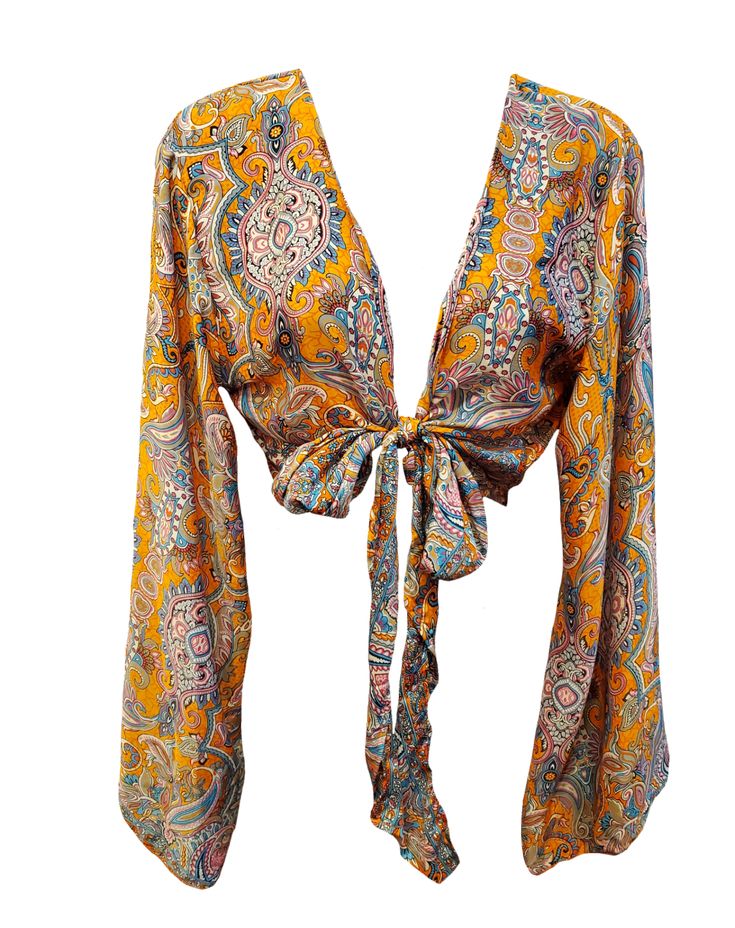 Get comfy in style with our Orange Blossom Boho Bell Sleeve Tie Top! Featuring adjustable tie front and bell sleeves, this top is perfect for the free-spirited fashionista. Let the paisley print add some hippie vibes to your wardrobe! (Free-spirited fashion included!) Bell Sleeve Shirts, Flowy Long Sleeve Tops With A Free-spirited Style, Long Sleeve Boho Top For Vacation, Free-spirited Long Sleeve Vacation Tops, Boho Print Tops For Fall Festival, Flowy Bell Sleeve Tops For Festival, Casual Printed Peasant Top For Festivals, Hippie Boho Print Peasant Top For Fall, Flowy Hippie Peasant Top For The Beach