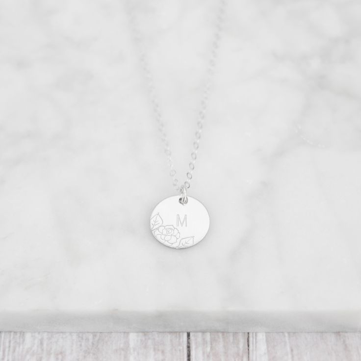 Introducing our stunning 1/2" disc necklace, featuring a beautifully hand-stamped floral design. This necklace is fully customizable, with the option to add up to three discs to the chain, each of which can be personalized with a single initial. Crafted with care, this necklace is a unique and meaningful addition to any jewelry collection, perfect for gifting to a loved one or treating yourself. Personalized Sterling Silver Round Pendant Medallion Necklace, Silver Round Disc Name Necklace, Personalized Silver Coin Necklace With Initial Pendant, Initial A, Disc Necklace, Initial Necklace, Hand Stamped, Jewelry Collection, Initials