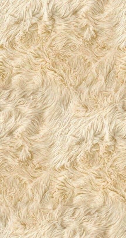 a white fur textured background that looks like it has been made out of sheep's wool