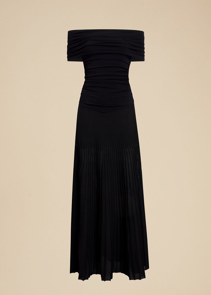 Description With pieces such as this draped jersey dress, Spring/Summer 2022 proposes a definitive New York wardrobe. The columnar silhouette is framed by a banded off-the-shoulder neckline that flows to a softly ruched bodice, the hint of a Basque waistline, and a ribbed skirt for fluted, floor-length fluidity. Details Material: Stretch matte viscose (83% viscose, 17% polyester) Care: Dry clean Fit: Designed for a close fit. Expect a tight fit at shoulder and waist. Recommended to take your nor Black Ruched Maxi Dress In Elastane, Evening Stretch Pleated Midi Dress, Black Draped Dress With Folds, Fitted Draped Viscose Maxi Dress, Black Pleated Draped Dress, Fitted Maxi Dress With Folds, Black Ruched Off-shoulder Maxi Dress, Black Dress With Folds For Night Out, Evening Ruched Viscose Maxi Dress