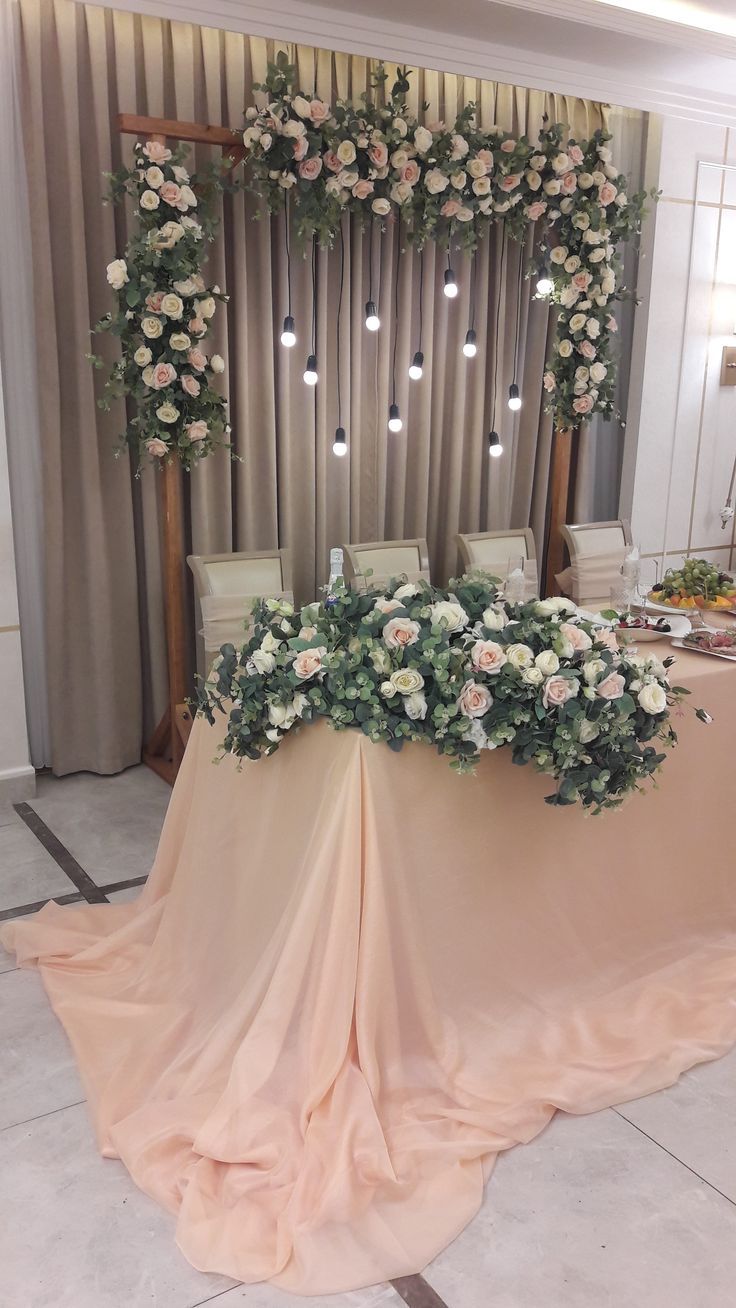 the table is covered with flowers and greenery