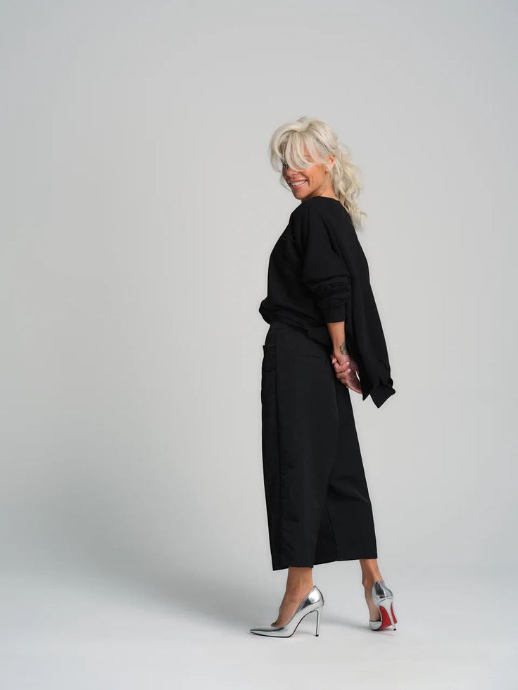 Our pants have an oversized boxy silhouette and a cropped length, the perfect combination of relaxed and stylish. Wear yours with your favorite funky top. We are bringing discreet chic back with our elevated black top. The subtle eyelet details and asymmetric hem lend this piece a subversive edge that’s easy to style in various looks. 100% Handmade products. SIZE & FIT:Fit: A relaxed fit with room to moveModel is wearing size Small or S/MView our SIZE CHART before ordering MATERIALS & CARE: PANTS: 100%Polyester TOP: 65% Cotton, 35% Polyester Care: Machine wash on cold (30ºC) with a mild detergent.SHIPPING:Made to order, processing time is 15 working daysThis item will be shipped via DHL Chic Long Sleeve Sets For Day Out, Chic Sets For Day Out, Chic Wide-leg Pants Sets, Casual Fall Sets With Wide-leg Pants, Chic Wide-leg Pants Set For Night Out, Chic Oversized Cotton Pants, Chic Cotton Two-piece Set, Chic Cropped Pants Two-piece Set, Chic Oversized Straight Pants