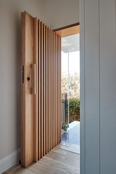 an open door leading to a room with wooden slats on the outside and inside