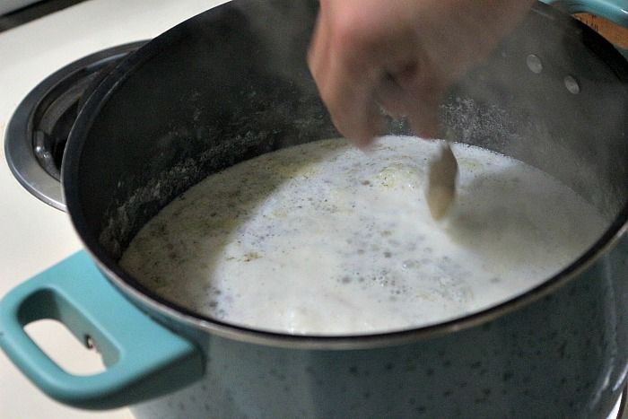 someone is stirring something in a pot on the stove