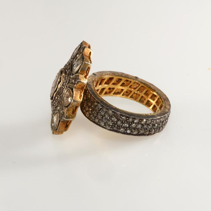 This is part of Chairish’s Fine Jewelry assortment.  Antique-look ring in a Georgian revival style. Crafted of gold plated sterling silver embellished with genuine diamonds. The larger diamonds on the top are rose cut while the pave' set accent stones are faceted. The pave' stones encircle the entire band. We believe this ring dates to c. 2000. It was purchased by the original owner in New York at the time Barney's was selling this style of ring for more than twice the price. Unmarked. Fits a si Luxury Jewelry With Rose Cut Diamonds In Diamond White, Luxury Rose Cut Diamond White Jewelry, Luxury Oval Cluster Ring With Single Cut Diamonds, Elegant White Gold Dome Ring With Rose Cut Diamonds, Fine Jewelry Cluster Ring With Rose Cut Diamonds, Luxury Diamond Dome Ring With Open Design, Luxury Diamond Dome Ring With Open Shape, Luxury White Gold Rings With Rose Cut Diamonds, Luxury Diamond Dome Open Ring