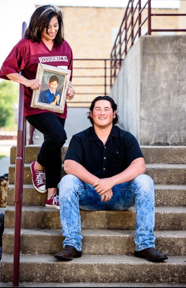 a man and woman sitting on the steps with a newspaper in front of their faces