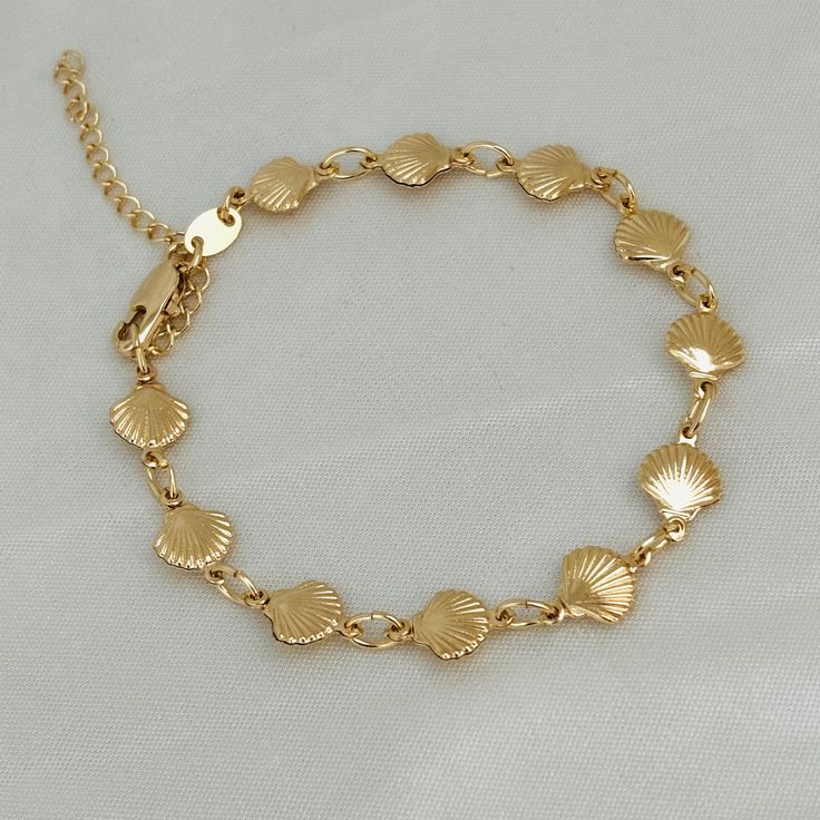 "It introduces the \"Golden Seashell\" Women's Gold-Filled Seashell Bracelet - a stunning and exquisite piece of jewelry that captures the essence of the ocean's beauty in every gleaming detail. -Material: 18K Gold Filled Item Description - Seashell Bracelet Width: 8mm - Seashell Bracelet length: 7.5 with two extra extensions  BENEFITS -Hypoallergenic -Water Resistant -Perfect for all time. -High-quality Bracelet! JEWELRY CARE: - All our garments will be accompanied by care instructions, a bag t Summer Jewelry Bracelets, Seashell Charm Bracelet, Gold Shell Jewelry, Gold Shell Bracelet, Cute Gold Bracelets, God Jewellery, Sea Shell Bracelet, Bracelet Ocean, Golden Jewellery