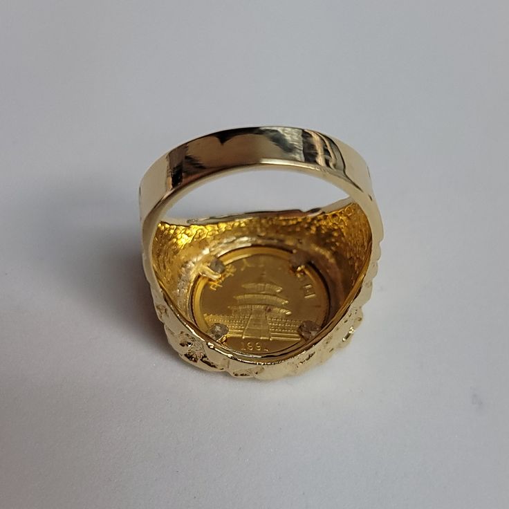 ♥ Coin Information ♥Type: CoinMetal Content: 1/20OZCountry: ChinaDenomination: 5 YuanComposition: .999 GoldYear: 1991♥ Ring Information ♥Details: Nugget Band Material: 14k Yellow GoldDimensions: 19mm x 20mm Weight: 12 Grams Size: 9.75Size can be adjusted – one size up/down is $50 two sizes up/down is $60. Once ring is adjusted it is final sale. Collectible 14k Gold Diamond Ring, Gold Signet Ring With Prong Setting, Hallmarked Yellow Gold Engraved Collectible Ring, Gold Rings With Certificate Of Authenticity For Anniversary, Gold Jewelry With Certificate Of Authenticity For Anniversary, Gold Jewelry For Anniversary With Certificate Of Authenticity, Yellow Gold Hallmarked Engraved Ring For Commemoration, 14k Yellow Gold Jewelry With Certificate Of Authenticity, Antique Yellow Gold Rings For Commemoration