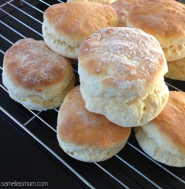 several biscuits cooling on a grill with powdered sugar