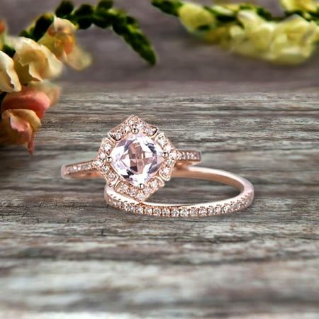 a close up of a ring on top of a wooden table with flowers in the background