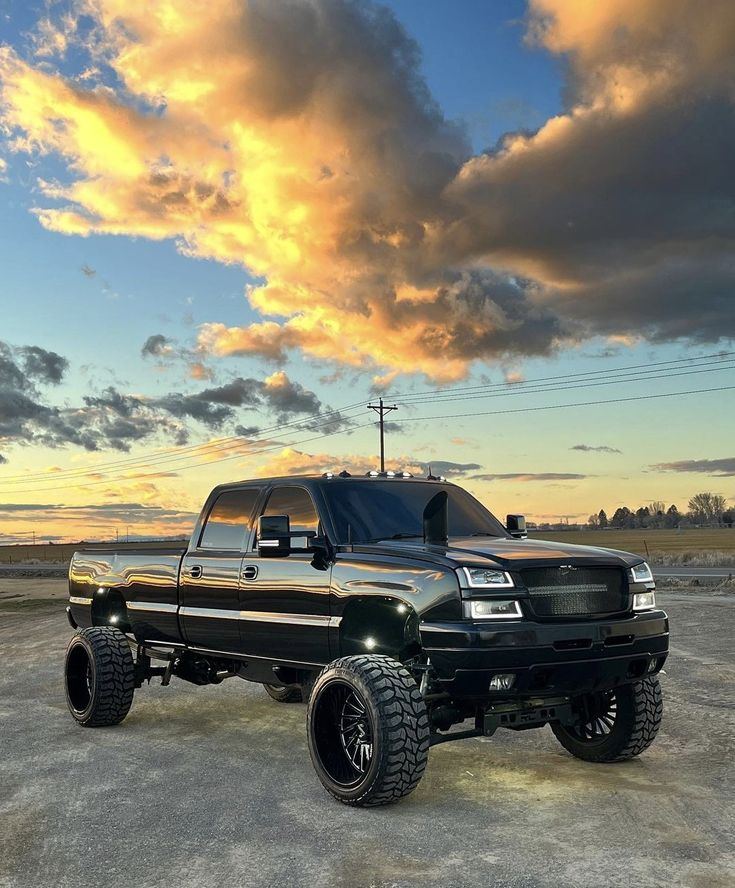 a large black truck parked on top of a parking lot