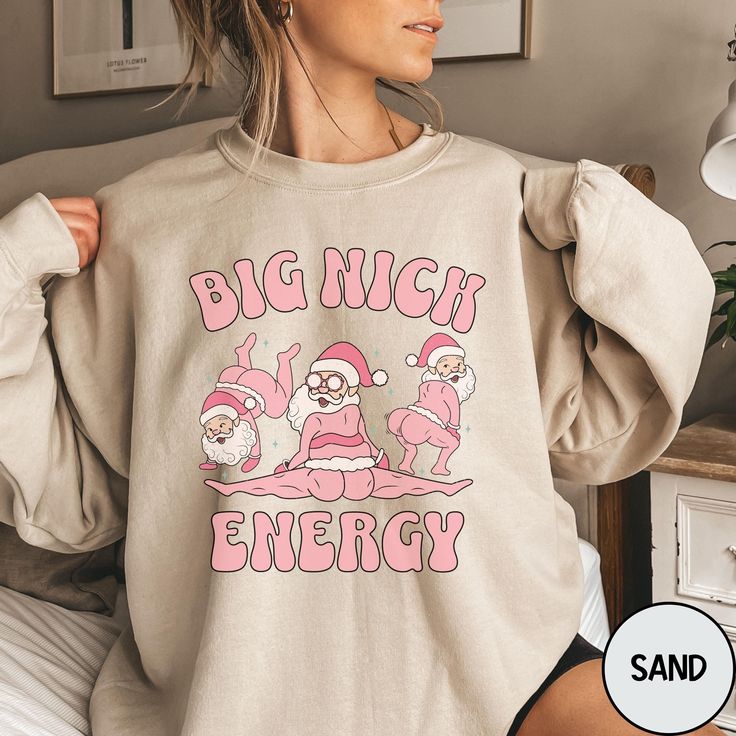 Spread holiday cheer with a twist in our "Big Nick Energy" Christmas Shirt, perfect for anyone looking to add some humor to the season. Featuring a playful retro Santa Claus design, this funny shirt brings big laughs and festive vibes to any holiday gathering. Ideal for both women and men, it's also a great pick for those who love bold, funny, and gay-friendly holiday apparel! Gildan 18000 Brand Sweatshirt ▶Unisex Adult Sizing ▶See Our Size Chart for Proper Sizing ▶Any rolled sleeves are for sty Big Nick Energy, Gay Shirts, Funny Christmas Tshirts, Retro Santa, Holiday Apparel, Tshirt Ideas, In This House, Funny Christmas Shirts, Rolled Sleeves