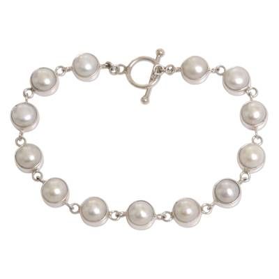 Nyoman Rena highlights the legendary beauty of pearls in the classic design of this bracelet. It is crafted with sterling silver offering an exquisite contrast with the pearls' shimmering elegance. .925 Sterling silver Adjustable Sterling Silver Pearl Drop Bracelet, White Gold Sterling Silver Bracelets With Pearl Chain, White Gold Sterling Silver Bracelet With Pearl Chain, Sterling Silver White Gold Bracelets With Pearl Chain, Pearl White Bracelet With Sterling Silver Clasp As Gift, Classic Sterling Silver Pearl Bracelet As Gift, Classic Sterling Silver Pearl Bracelet For Gift, Silver Sterling Bracelets With Pearl Charm, Silver Sterling Silver Bracelets With Pearl Charm