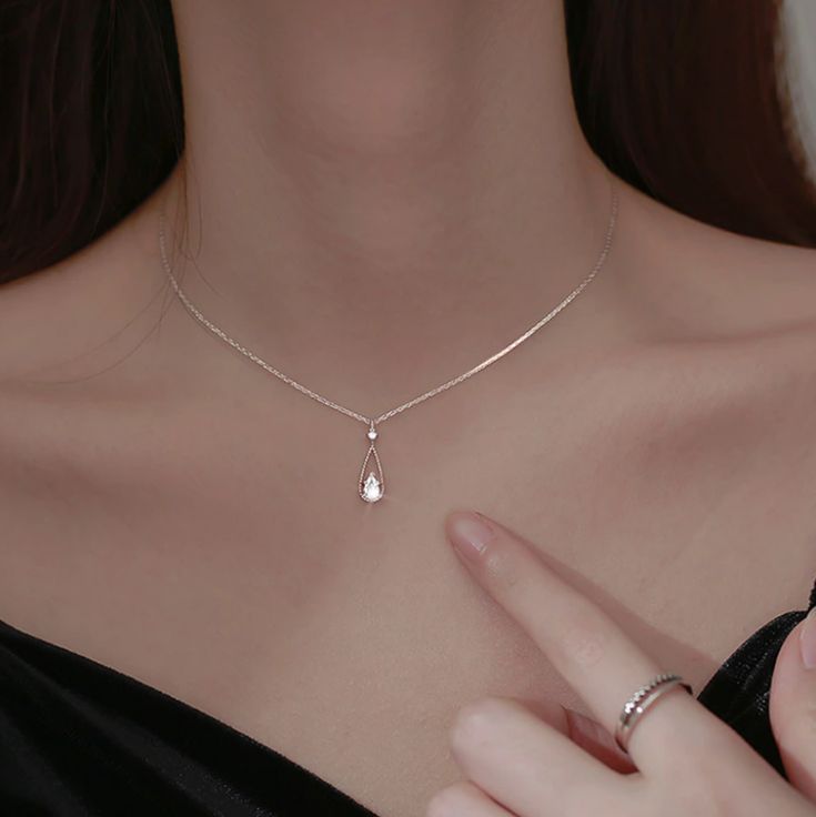 This sparkling, delicate zirconia sits on a pear shaped water drop pendant giving the necklace an elegant touch. The necklace creates a stylish look that can be styled with any outfit. Wear it alone or layered it with our other necklaces. Details 18K Gold Plated on 925 Sterling Silver with zircon stones Chain: 16" + 2" extender Pendant Size: 0.12" by 0.17" Dainty & Fine Delivered in Poppy Mae custom jewelry boxes ready to be gifted Avoid contact with any chemicals or alcohol. Please refer to our Simple Elegant Necklace, Silver Necklace Simple, Pretty Jewelry Necklaces, French Jewelry, Prom Jewelry, Jewelry Lookbook, Teardrop Necklace, Affordable Jewelry, Elegant Necklaces